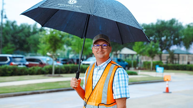 Adults meeting before service reviewing volunteer assignments
